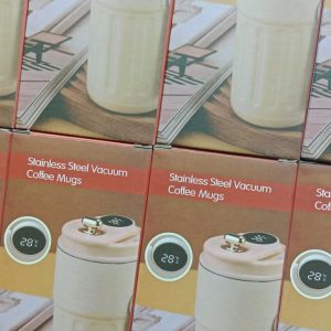 Stainless Steel Vacuum Coffee Mug, a portable insulated tumbler featuring a digital LED temperature display on the lid, a textured exterior, and a secure flip-top opening. Key Features